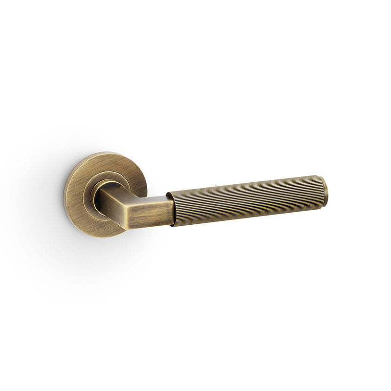 Alexander and Wilks - Hurricane Reeded Lever on Round Rose - Antique Brass - AW202AB