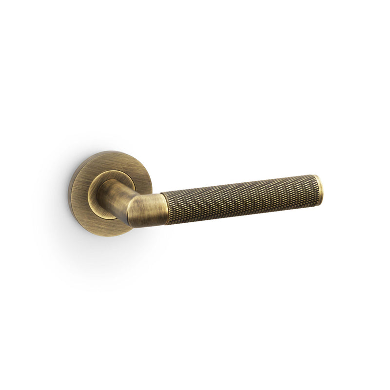 Alexander and Wilks - Harrier Knurled Lever on Round Rose - Antique Brass - AW210AB