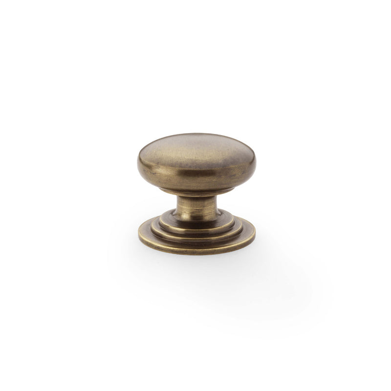 Alexander and Wilks - Waltz Round Cupboard Knob on Stepped Rose - Antique Brass - Knob 32mm - AW825-32-AB